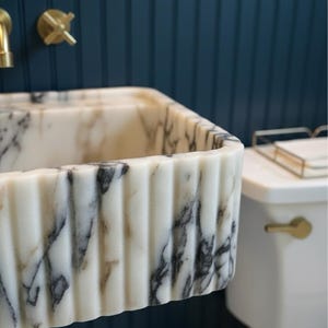 Handcarved Calacatta Viola marble wall mounted sink by Marblyart, custom made to order — photo 10 of 11