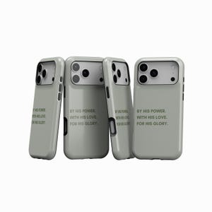 May include: Four sage green phone cases. Each case has a camera cutout and the text "BY HIS POWER, WITH HIS LOVE, FOR HIS GLORY." The cases are displayed against a white background.