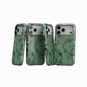 May include: Four smartphone cases with a green background and a repeating pattern of monkeys, flowers, and branches. The cases have a glossy finish. The cases are displayed at a slight angle.