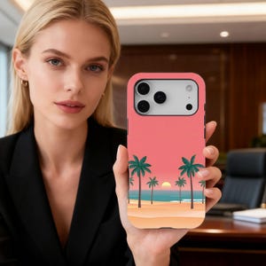 May include: A coral-colored phone case featuring a beach scene with palm trees, a setting sun, and a sandy shore. The case has a smooth finish and a camera cutout for a smartphone.