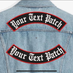 May include: Two black and red embroidered patches with white text that reads "Your Text Patch" on a blue denim vest.