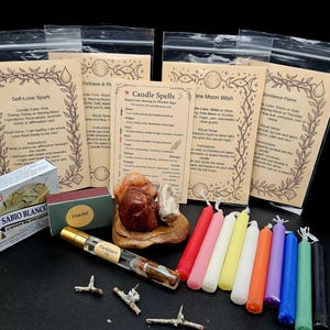 May include: An assortment of spiritual items, including candles, incense, matches, crystals, and spell cards. The candles are in various colors, and the spell cards have text. The items are arranged on a dark surface, suggesting a mystical or ritualistic theme.