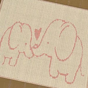 May include: A rectangular rug with a cream background and a pink elephant design. Two elephants face each other, with a pink heart between their trunks. The rug has a textured appearance.