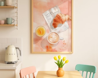 May include: A framed watercolor print depicts a breakfast scene. A croissant, coffee, and orange juice sit on a newspaper. A small vase of yellow tulips sits on a wooden table. The print is in a room with a white kettle and colorful chairs.