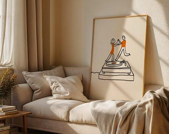 May include: A framed rectangular wall art print featuring a black line drawing of two figures dancing on top of a record player. The figures are filled with solid orange color, and the background of the print is a neutral cream color.