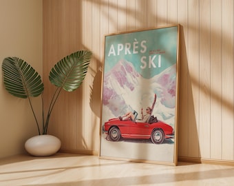 May include: A framed vintage-style poster with the words "APRÈS SKI" in white letters. The poster depicts a red convertible car with a person inside, set against a snowy mountain backdrop. The poster is in a wooden frame and leans against a wall.