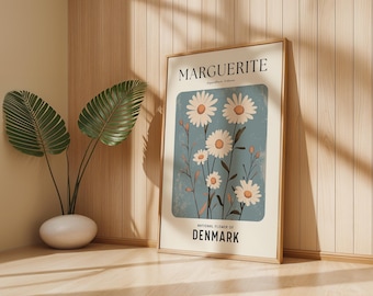 May include: A framed poster featuring a botanical illustration of daisies, with the text "MARGUERITE" and "NATIONAL FLOWER OF DENMARK." The artwork has a light blue background and a beige border, with a wooden frame.