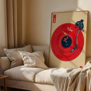 May include: A framed art print featuring a red vinyl record design with koi fish illustrations. The record player arm and headshell are black. The artwork is displayed on a beige background with Japanese text in the upper left corner.