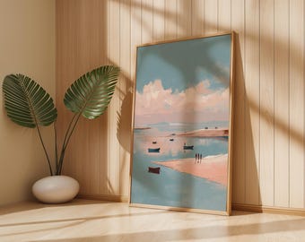 May include: A framed art print depicting a serene coastal scene. The artwork features a pastel color palette with a light blue sky, pink clouds, and a sandy beach. Several small boats are visible on the water. The print is displayed on a wooden floor.