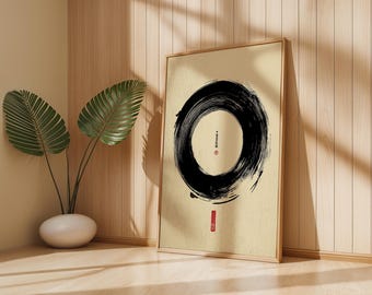 May include: A framed artwork featuring a large black brushstroke circle on a beige background. The artwork has Japanese text and a red seal. The frame is light brown, and the artwork is leaning against a wooden wall. A potted plant with large green leaves is in the corner.