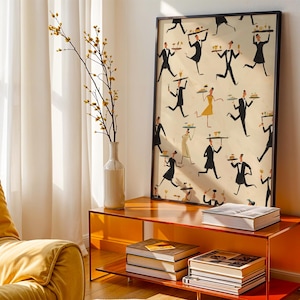 May include: A framed art print featuring a repeating pattern of waiters in black suits and bow ties carrying trays. The artwork has a vintage style with a cream-colored background. The print is displayed on an orange console table with books and a vase.