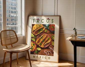 Op de afbeelding: Een ingelijste kunstdruk met een kleurrijke illustratie van taco's op een houten tafel. De tekst TACOS staat bovenaan met kleine sombrero's en MÉXICO onderaan. De afbeelding toont borden met taco's, limoenpartjes en uienringen.