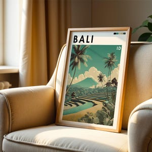 May include: A framed art print featuring a Bali landscape with palm trees, terraced rice fields, and a mountain. The word "BALI" is at the top, with "ID" below. The artwork has a vintage travel poster style, with a color palette of teal, beige, and green.