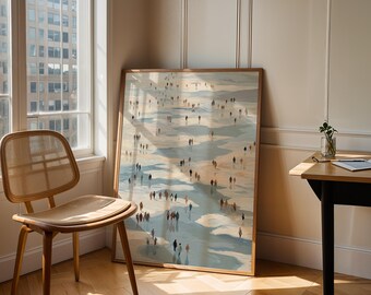 May include: A framed art print depicts a beach scene with numerous tiny figures. The artwork, in shades of blue, beige, and brown, leans against a wall near a window and a wooden chair. The room has a warm, inviting atmosphere.