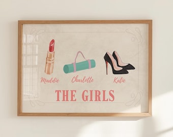 May include: A framed print featuring illustrations of a lipstick, a yoga mat, and a pair of high heels. The names "Maddie", "Charlotte", and "Katie" are below each item, with the text "THE GIRLS" at the bottom.