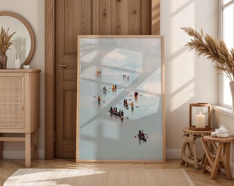 May include: A framed art print depicts several small boats with people rowing on a body of water. The artwork has a light blue and white color palette, with a wooden frame. The print is displayed in a well-lit room with wooden furniture.