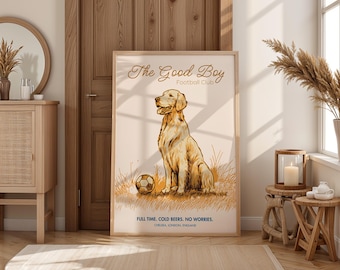 May include: A framed print featuring a golden retriever sitting next to a soccer ball. The text reads "The Good Boy Football Club" and "Full Time, Cold Beers, No Worries." The print has a light beige background and a wooden frame.