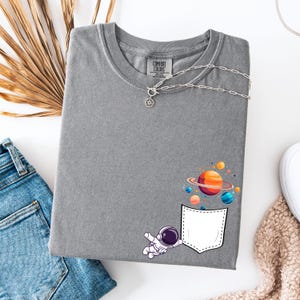 Comfort Colors Astronaut Pocket T-Shirt: Funny Galaxy Graphic Tee