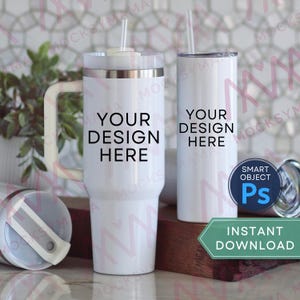 May include: Two white tumblers with straws, one with a handle. The text "YOUR DESIGN HERE" is printed on both tumblers. A blue circle with "SMART OBJECT Ps" is visible, along with a green banner that says "INSTANT DOWNLOAD".