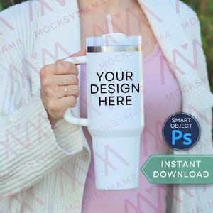 May include: A white tumbler with a handle, lid, and straw. The text "YOUR DESIGN HERE" is printed on the front. A blue circle with "SMART OBJECT Ps" is in the lower right corner. The words "INSTANT DOWNLOAD" are in a green banner.