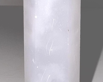 May include: A light purple crystal point with a faceted top. The crystal is a pale lavender color and has a smooth, polished surface. The crystal is approximately 6 inches tall.