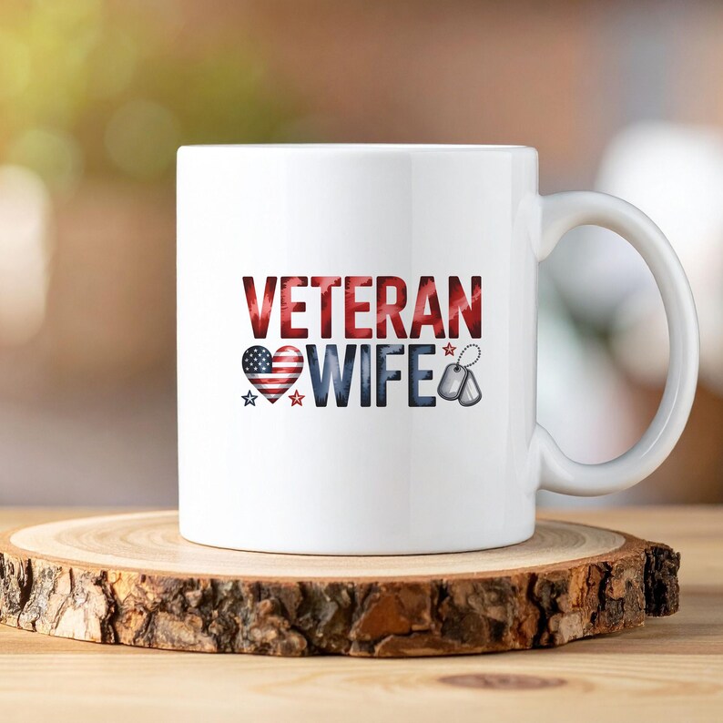 May include: White ceramic mug with the words "VETERAN WIFE" in red, white, and blue. The design includes a heart with an American flag pattern, stars, and dog tags. The mug sits on a wooden slice.
