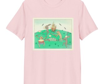 May include: Pink t-shirt with a graphic print of four cartoon animals playing music around a campfire. The animals are brown and have long ears. The graphic is in a vintage style.