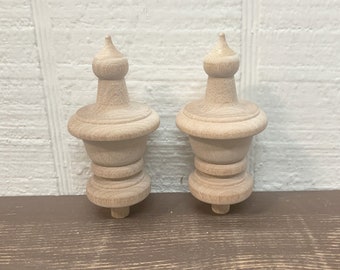 May include: Two unfinished wooden finials with a rounded top and a decorative base.