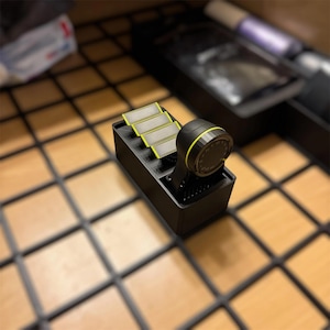 May include: A black and yellow electric shaver with three replacement heads. The shaver has a circular head with a digital display and a black handle. The replacement heads are rectangular with a yellow trim.