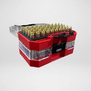 May include: A red and clear plastic ammunition storage box, partially open, filled with numerous brass-cased bullets. The box has a hinged lid and a black handle. The bullets are arranged neatly inside the box.