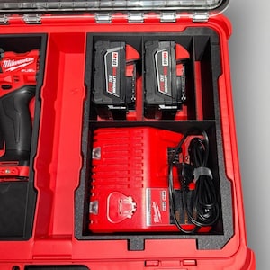 May include: A red tool case with black compartments holding a red and black drill, two black M18 REDLITHIUM XC 5.0 batteries, and a red charger. The case is open, revealing the tools and accessories.
