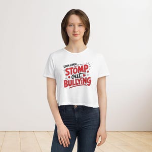 May include: White cropped t-shirt with a red graphic that says "Umm hmm... Stomp out Bullying" with hearts around the text.