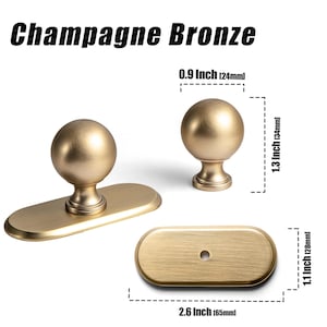 May include: Champagne Bronze cabinet hardware set. Includes a knob, a pull with a knob, and a rectangular backplate. The knob is 0.9 inches (24mm) in diameter, and the pull is 2.6 inches (65mm) long. The text "Champagne Bronze" is at the top.