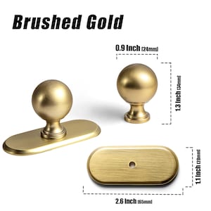 May include: Brushed gold cabinet hardware set. Includes a knob, a pull with an oval backplate, and a separate oval backplate. The knob is 0.9 inches (24mm) in diameter and 1.3 inches (34mm) tall. The pull is 2.6 inches (65mm) long.