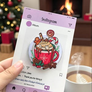 May include: A festive Christmas-themed pin featuring a red mug of hot chocolate with whipped cream, marshmallows, and a candy cane. The pin is displayed on a mock Instagram post with the text "Instagram" and "1314 Likes".