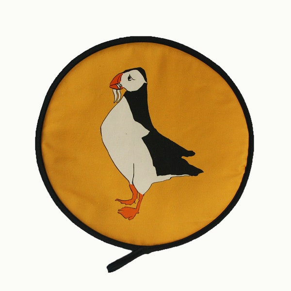Aga chef pad cover with Puffin design and yellow background