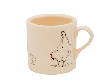 May include: A cream-colored ceramic mug featuring a minimalist black line drawing of a hen and a small chick. The hen has a small red accent on its comb. The mug has a smooth finish, a cylindrical body, and a curved handle on the right side.