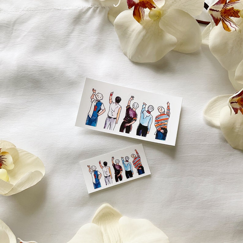 May include: Two rectangular stickers with a watercolour illustration of a group of people with raised arms. The figures wear diverse outfits, including a blue and white vest and striped shirts. The stickers are on a white background with white flowers.