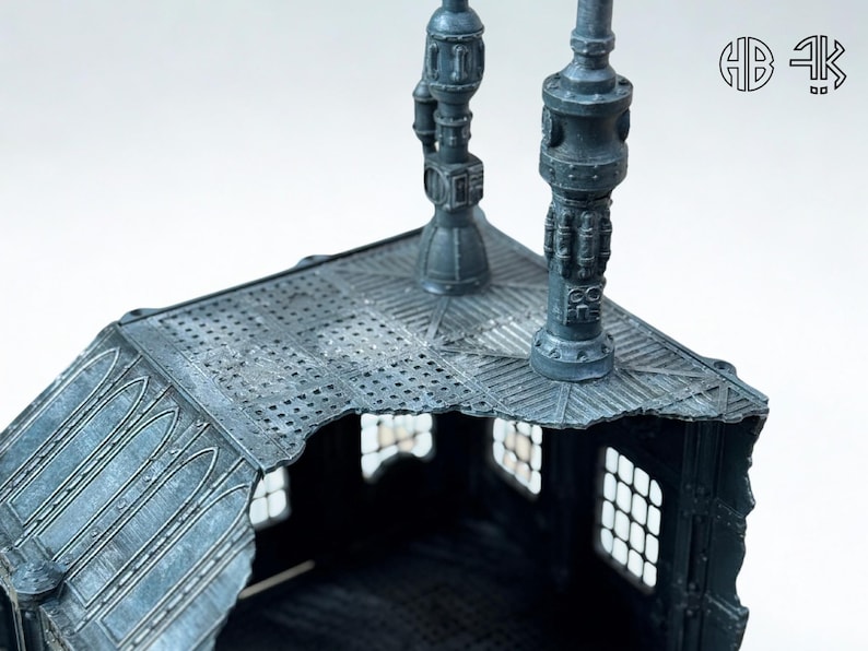 May include: A detailed, gray miniature building with a textured roof and decorative lampposts. The building has multiple windows and architectural details, suggesting a fantasy or sci-fi theme. The image is well-lit, highlighting the intricate design.