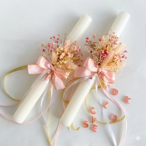 May include: A white ceramic mug with a black handle and the text "But First, Coffee" in a bold, black font. The mug is set against a blurred background, suggesting a cozy setting.