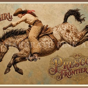 May include: A framed art print depicting a cowgirl in a tan hat, light shirt, and fringed chaps riding a bucking spotted horse. The text Spirit of the Cowgirl appears in the upper left, and Prescott Frontier Days is written in the lower right.