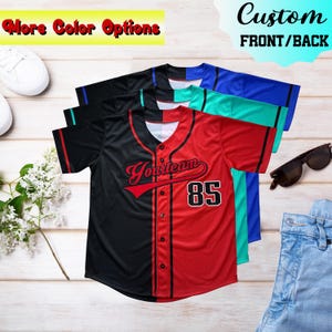 May include: Baseball jerseys in black, red, blue, and teal. The red and black jersey has the word "YourTeam" and the number "85" on it. The text "More Color Options" and "Custom Front/Back" are also visible.
