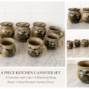May include: An 8-piece kitchen set comprising three ceramic canisters with lids and five matching mugs. Each item is beige with hand-painted green and orange fruit motifs. The canisters are labelled Coffee, Sugar, and Tea in cursive script.