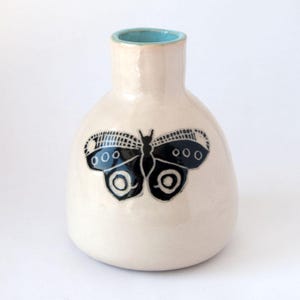 Hand built, hand painted vase, with butterfly design.