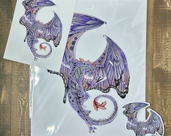 May include: A set of three purple and blue dragon stickers. The largest sticker features a detailed illustration of a dragon with wings that resemble butterfly wings. The dragon is curled in a circle with its tail in its mouth. The two smaller stickers feature a similar dragon design but are smaller in size.