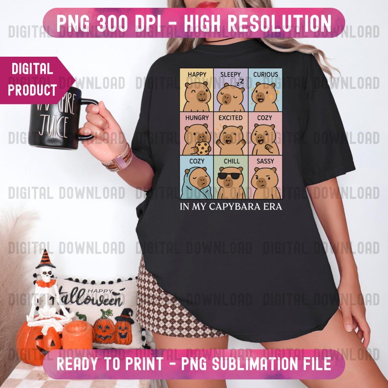 May include: Black t-shirt featuring a grid of capybara illustrations, each depicting a different emotion. The text "IN MY CAPYBARA ERA" is below the grid. The shirt also has the text "PNG 300 DPI - HIGH RESOLUTION" and "READY TO PRINT - PNG SUBLIMATION FILE".