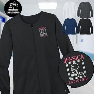 May include: Black zip-up medical scrub jacket with the name "Jessica" and "Radiology" embroidered in pink. The jacket features a skeleton graphic. Additional jackets in white, gray, navy, and black are also shown.