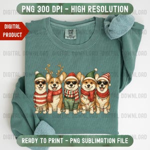 Peut inclure: Un sweat-shirt vert d'eau avec un motif de cinq chiens corgi vêtus de tenues de fête, notamment des bonnets de Père Noël, des écharpes et des lunettes de soleil. Le texte "PNG 300 DPI - HAUTE RÉSOLUTION" et "PRÊT À IMPRIMER - FICHIER DE SUBLIMATION PNG" sont visibles.