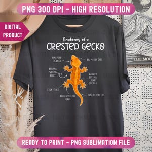 May include: Dark gray t-shirt featuring an orange illustration of a crested gecko with labeled anatomy. The text "Anatomy of a Crested Gecko" is above the illustration. The shirt is a digital product, ready to print.