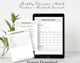 Może przedstawiać: Tablet wyświetlający drukowany kalendarz miesięczny, śledzenie nawyków i dziennik mentalny. Na ekranie widoczny jest tekst "Monthly Clarity Calendar", "Habit Clarity Tracker" i "Mindset Momentum Journal". Pod tabletem widnieje tekst "Instant Download".